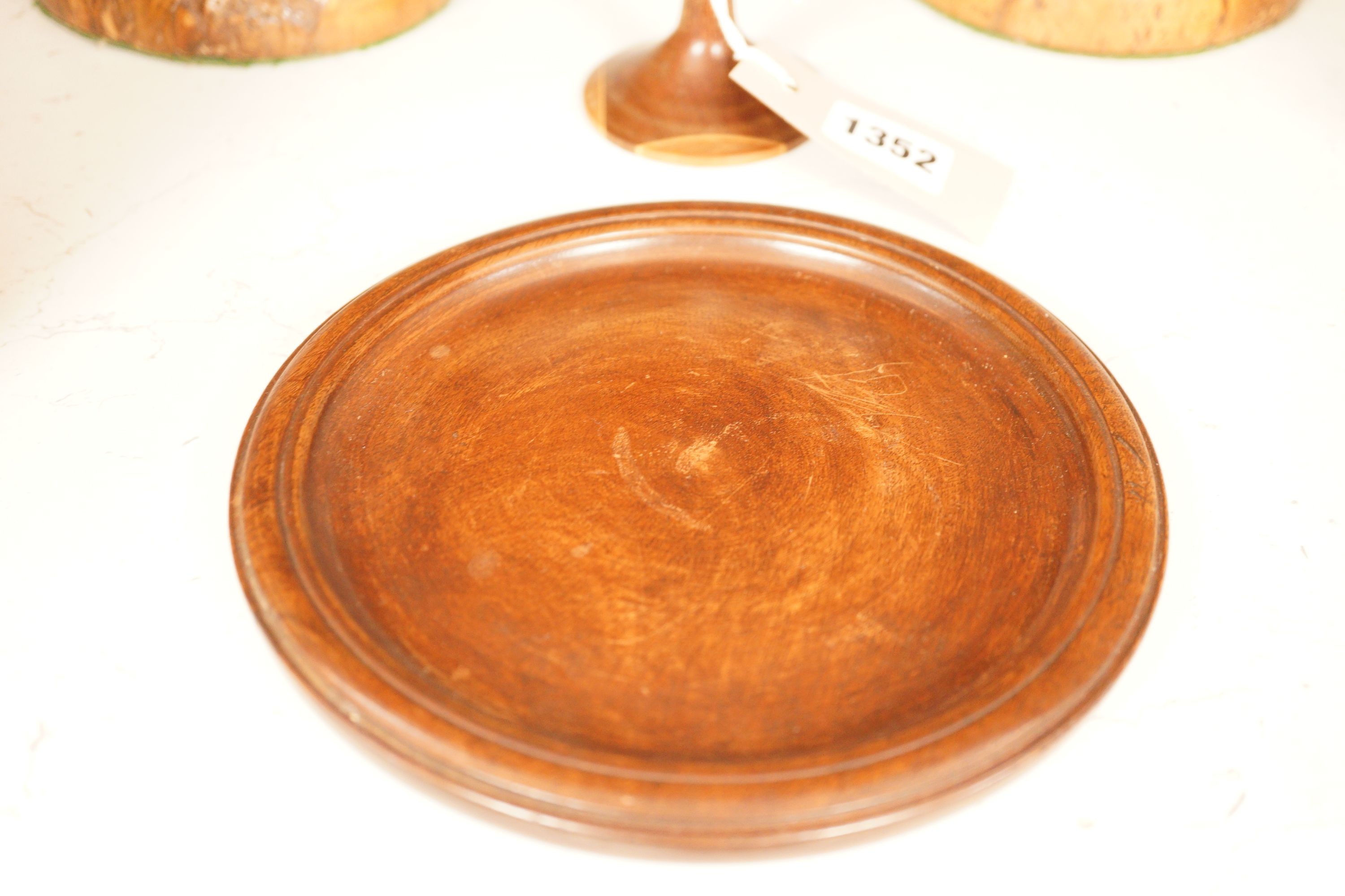 A treen goblet and cover, two candlesticks, a cup and a coaster